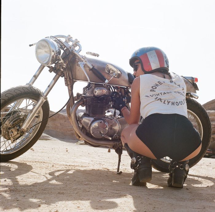 A playful frame from Girls on a motorcycle — online in Hebe